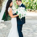 Bride and groom have a first look beneath a beautiful tree at their destination wedding in Punta Mita Mexico