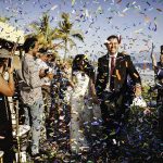 Bride and groom exit their ceremony to a biodegradable confetti toss at their destination wedding in Punta Mita, Mexico