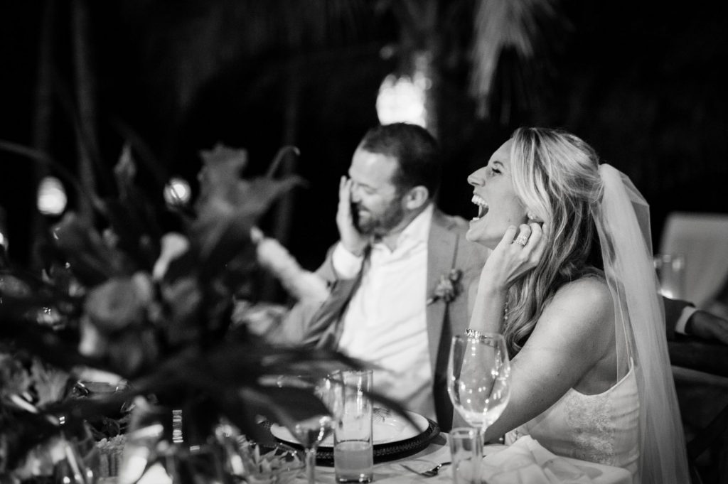 The bride and groom laugh during wedding speeches at this Sayulita mexico destination wedding.