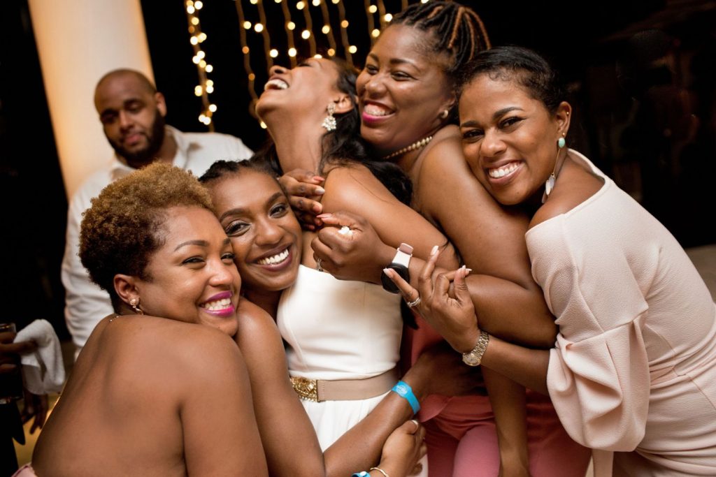 The bride gets hugs from her ladies on the dance floor at this Punta Mita Mexico destination wedding 