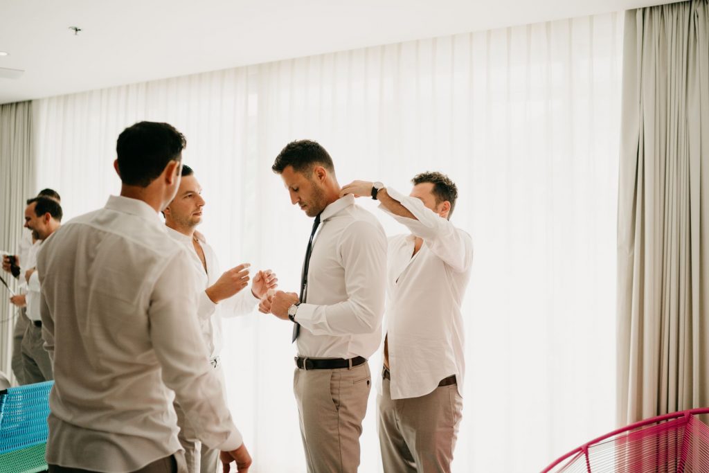 Groom getting ready with his groomsmen for his white wedding in punta mita mexico