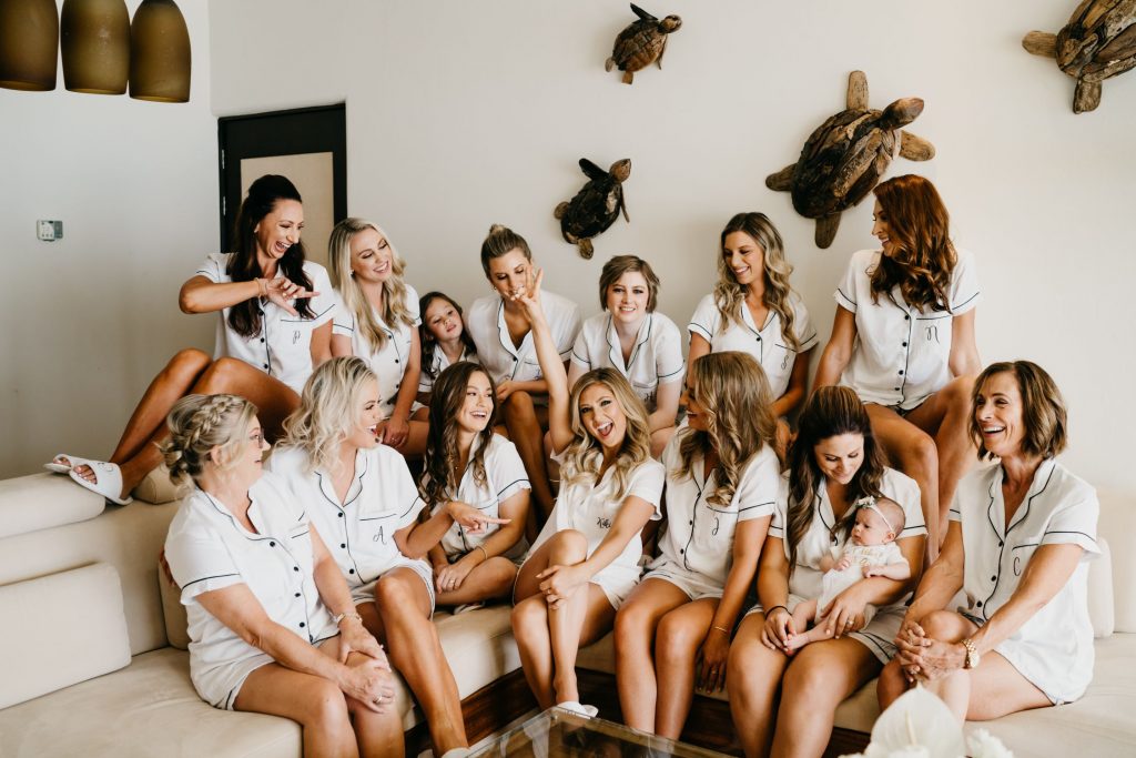 Bridesmaids and Bride celebrating in their matching white pj's before the wedding