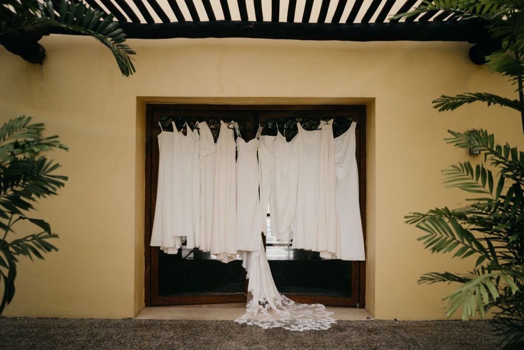 white wedding dress next to white bridesmaids dresses