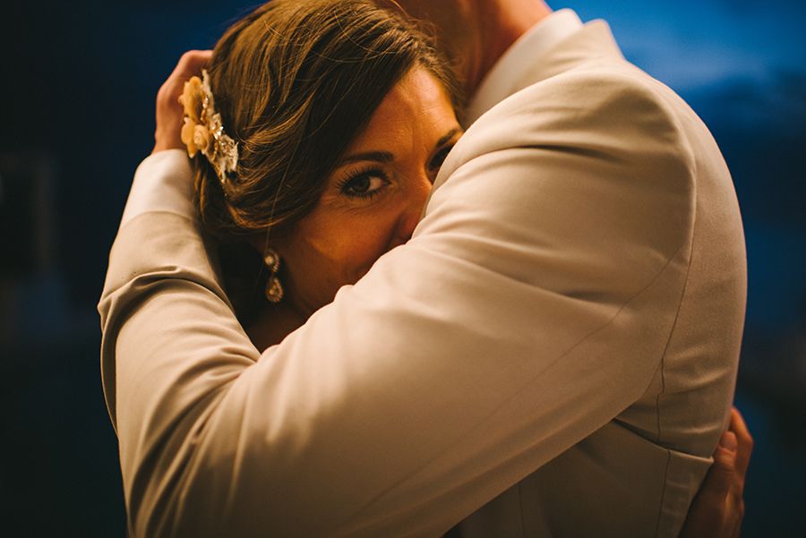 The bride peeks over the groom's shoulder in my top 15 wedding images at this destination wedding in PUnta Mita Mexico.