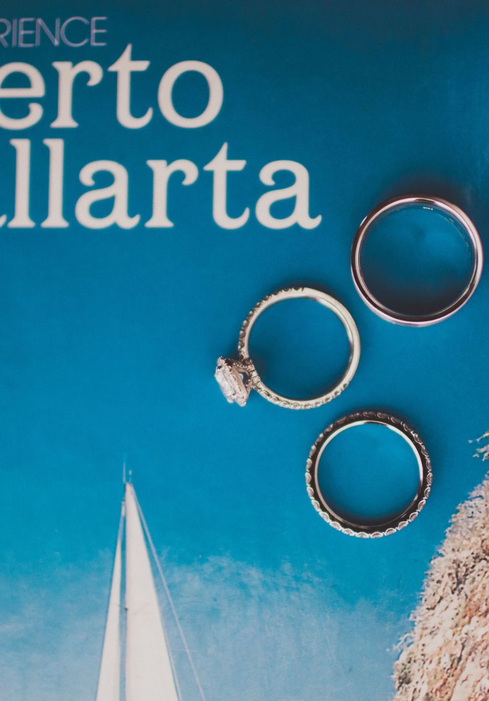 The wedding rings are set on a Puerto Vallarta tourism book for a creative photo at this destination wedding